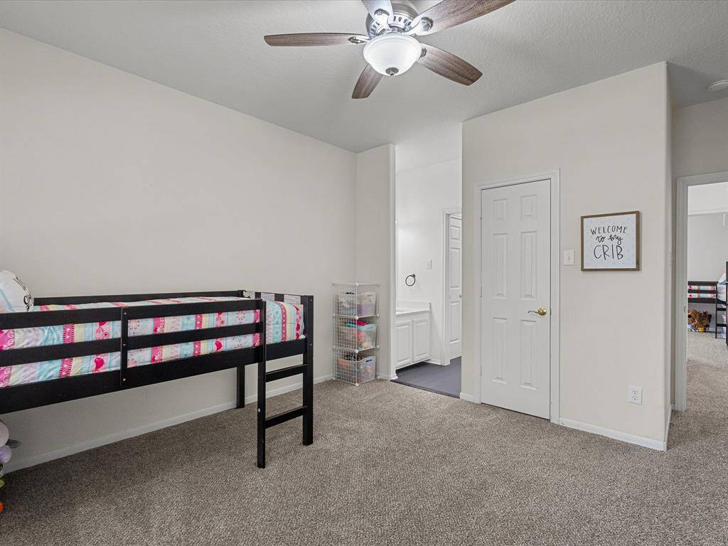 This cozy bedroom features carpeted floors, neutral walls and connects to a beautifully shared, updated bathroom.