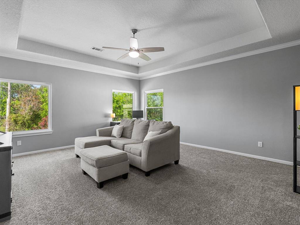 Large windows provide natural light and a stunning view of the backyard.