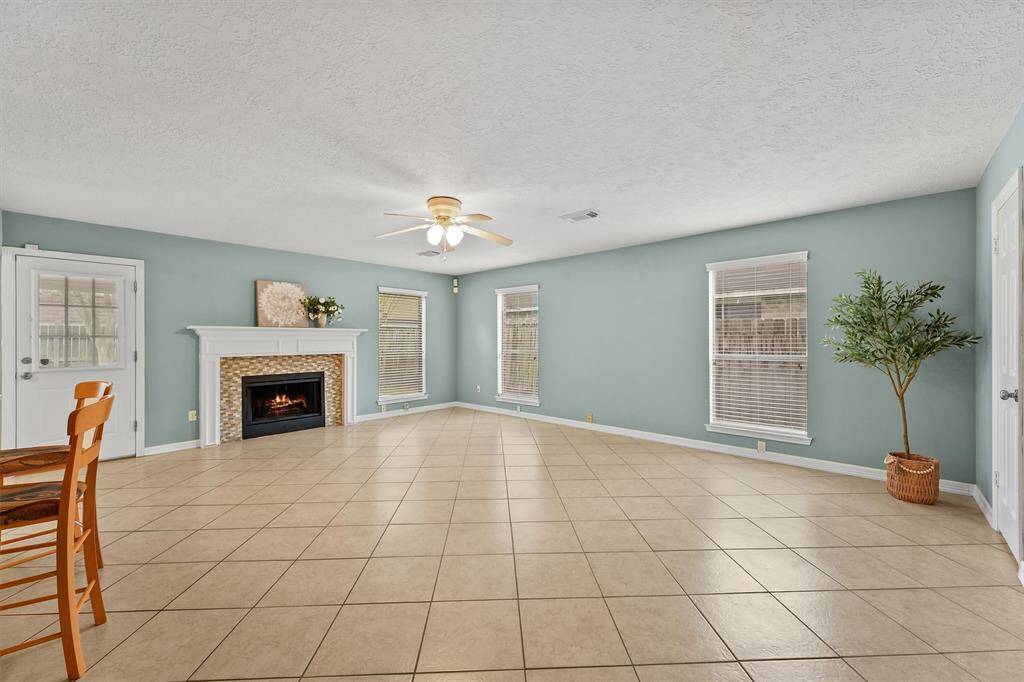 Spend cozy evenings curled up with a book in this inviting family room with a fireplace.