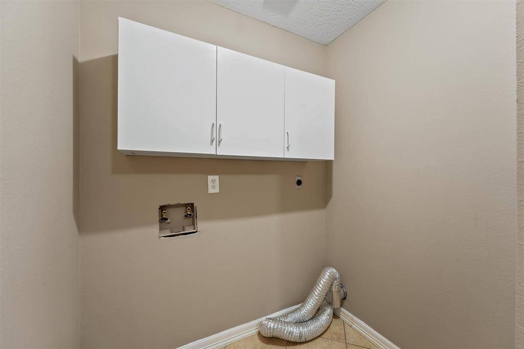 The laundry room is tucked away behind the pantry.