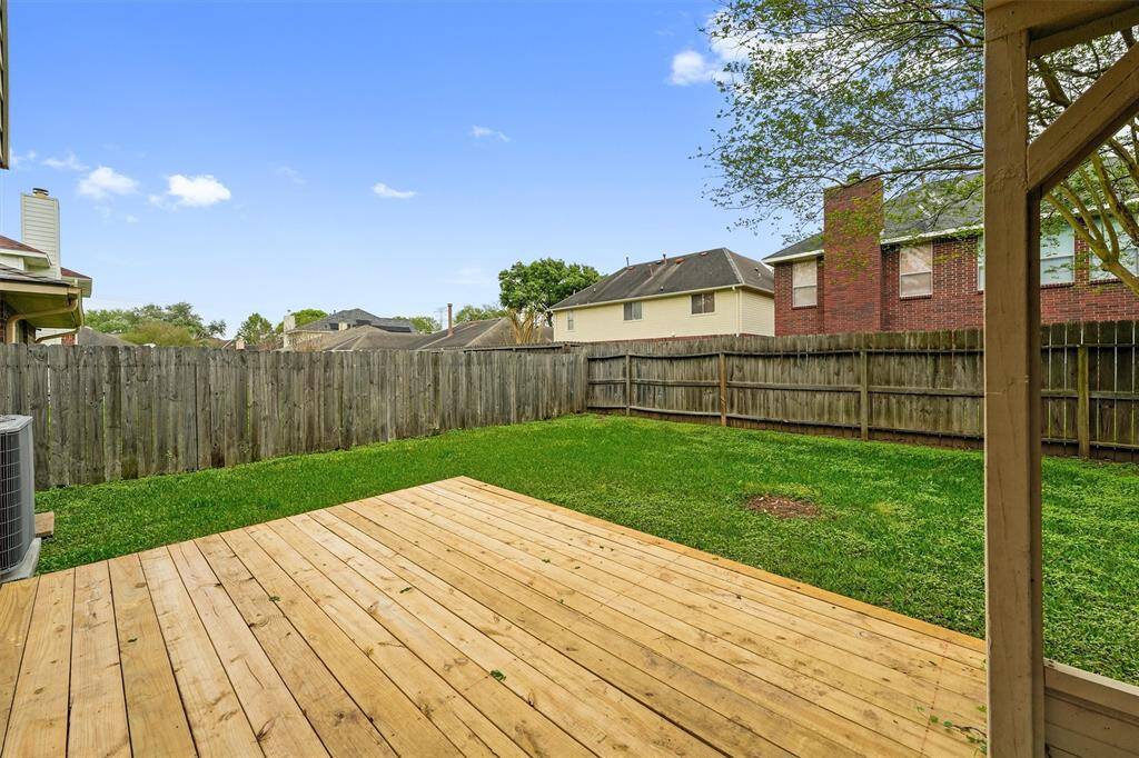 A wood deck is ready for summer barbecues, starlit dinners, and creating lasting memories with friends and family in your private backyard retreat.