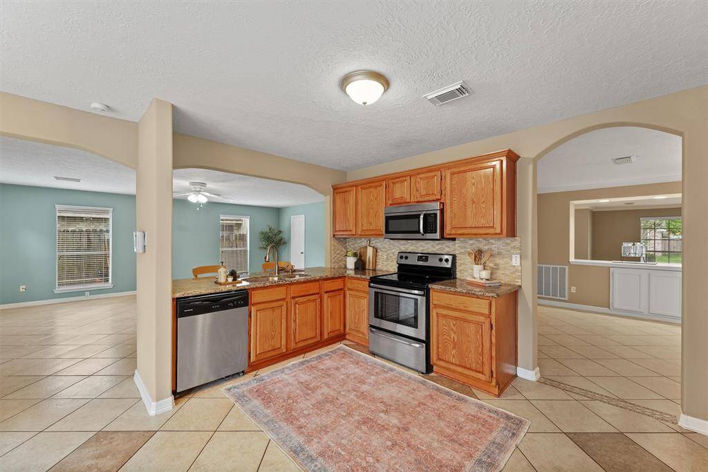 Prepare delicious meals while staying connected with loved ones in the large, open family room. Laughter and conversation flow freely between these inviting spaces.