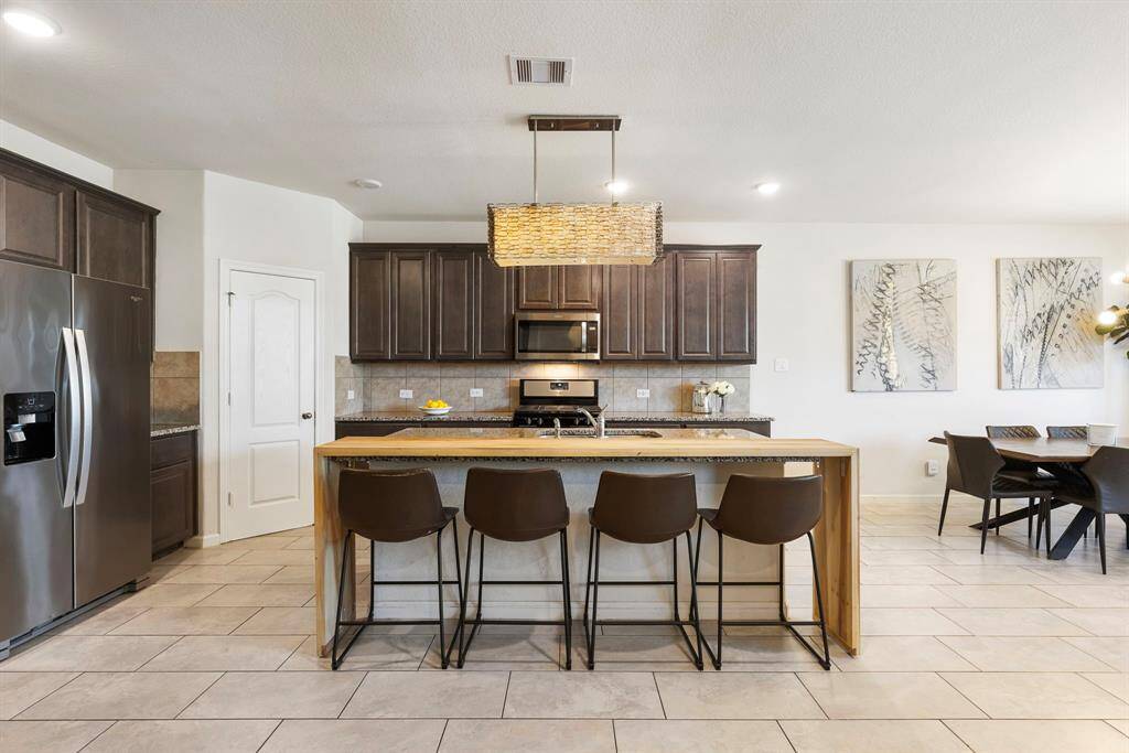 This sleek kitchen offers island seating and an open flow into the dining area and living room - perfect for entertaining.