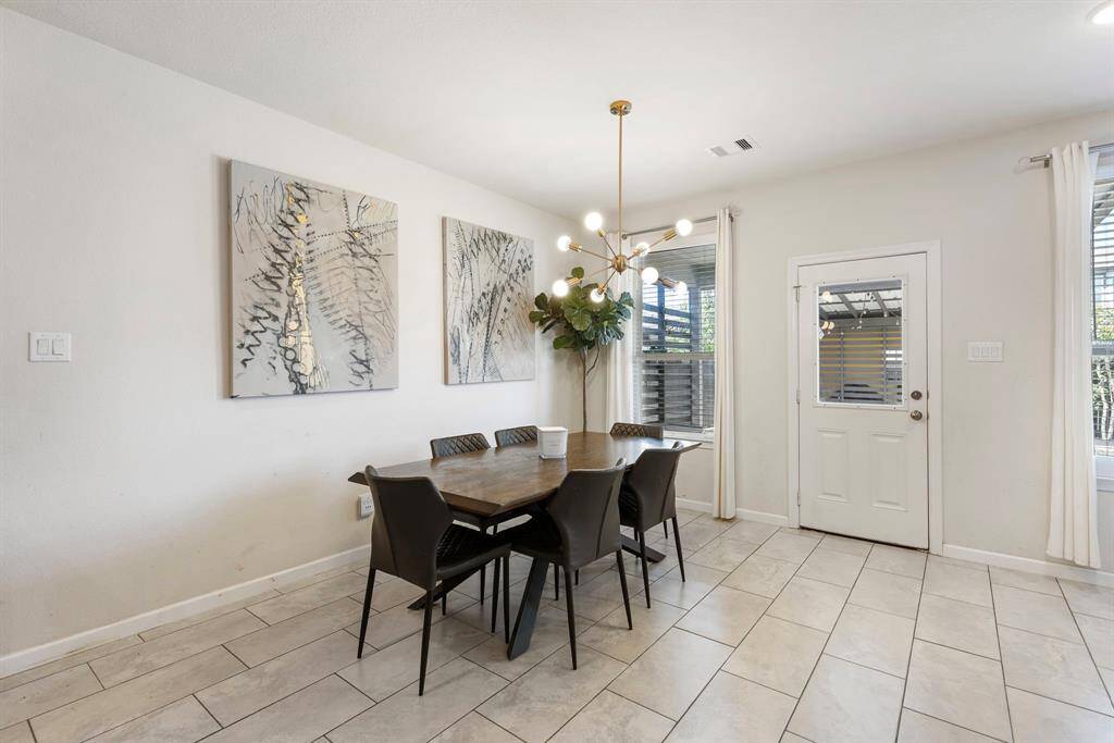 Dining area with upgraded modern lighting and plenty of natural light - perfect for everyday meals.