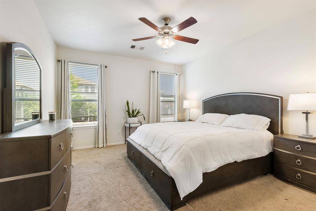 This primary suite offers a relaxing and calm ambiance with plenty of natural light-your perfect place to unwind.