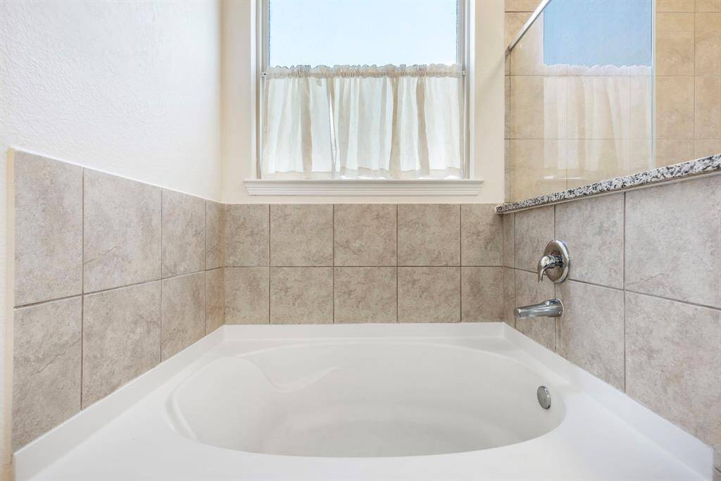 Relax in the soaker tub after a long day to unwind in comfort.