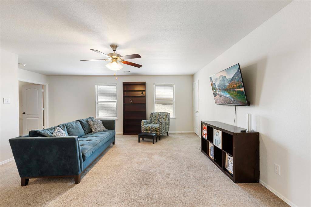 As you come up the stairs you are greeted with a spacious game room with lots of natural light & a storage closet.