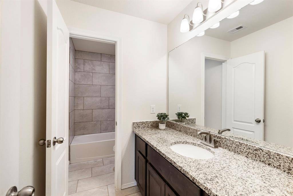 The secondary full bathroom upstairs features ample countertop space & has a privacy door from the tub/shower, making getting ready in the morning more convenient.