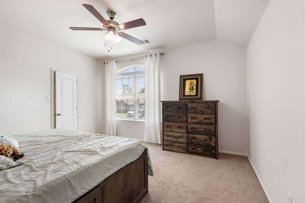 The second upstairs bedroom is a great size and features a ceiling fan and large walk-in closet.