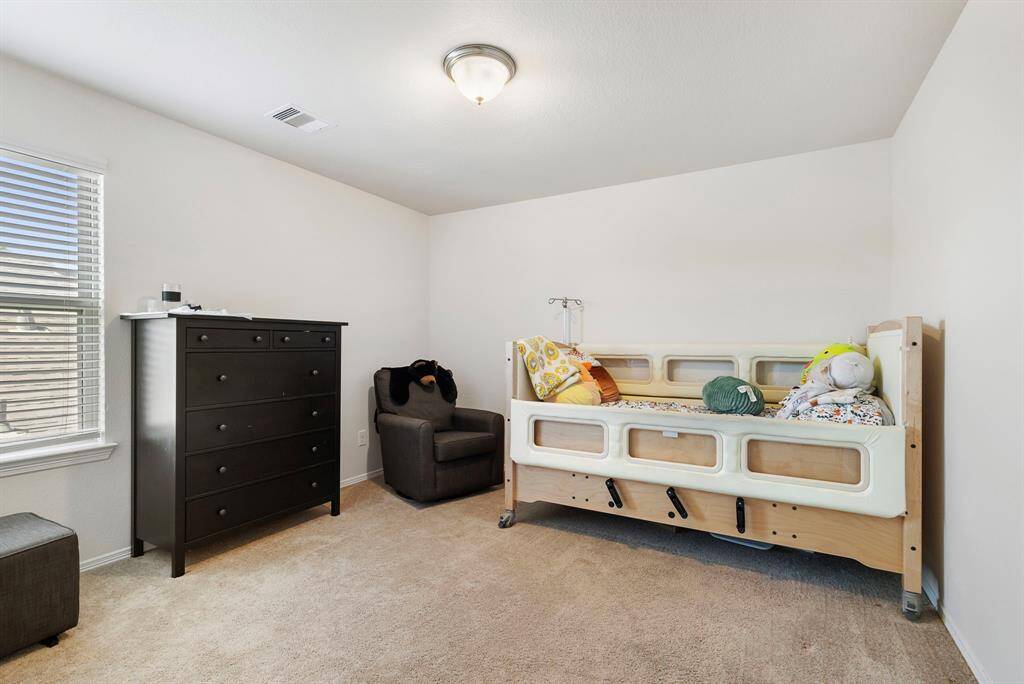 The third secondary bedroom upstairs also features a large closet for ample storage.