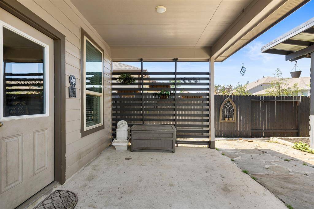 The outdoor area is perfect for relaxing. Notice the modern slate privacy wall with planters which add a coziness to the space.