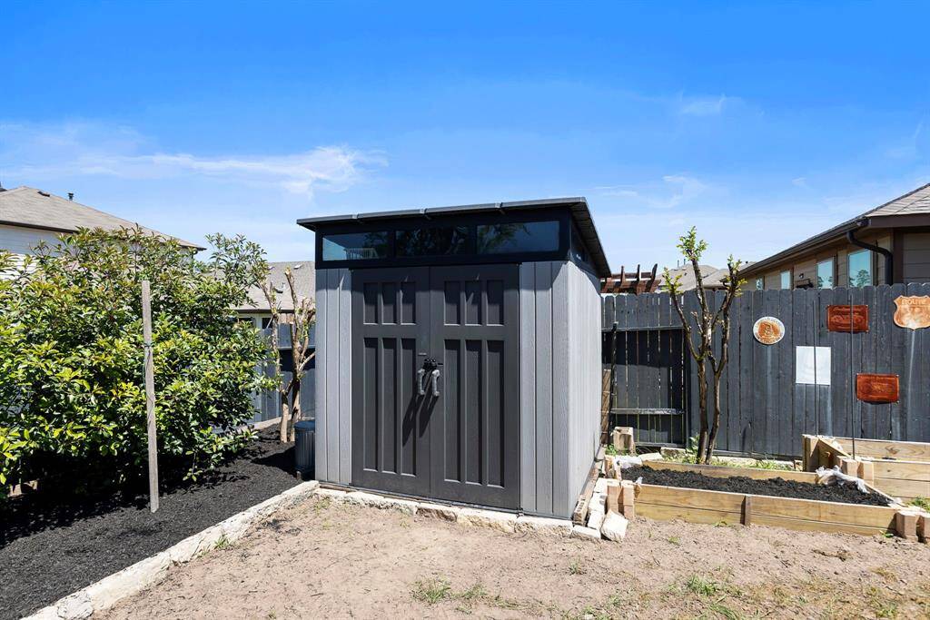 This storage shed is perfect for storing & organizing lawn equipment & tools. There is also overhead storage in the garage. The seller also added a side gate for added convenience.