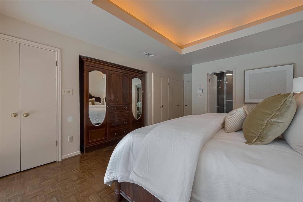 Another view of the primary bedroom. The doors along the wall are 3 closets. (There's also a walk-in closet within the bathroom).