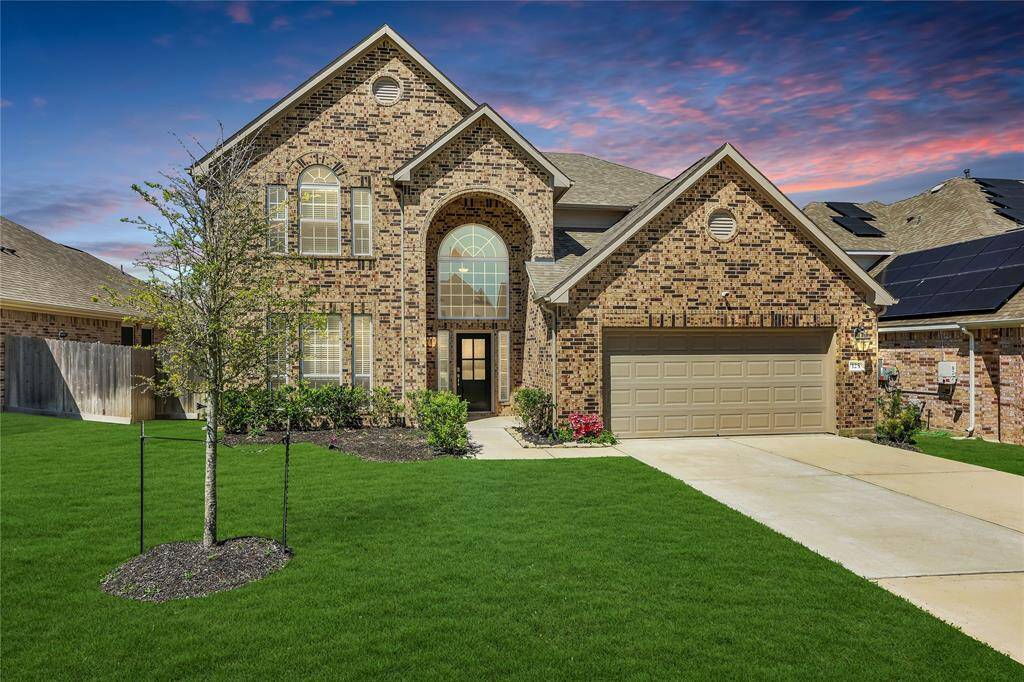 This expansive home boasts stunning landscaping and an elevated design that enhances its curb appeal.