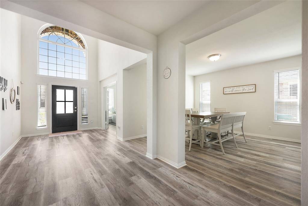 A grand entryway welcomes you, with a stylish office and elegant dining room on one side and convenient access to the laundry room and half bath on the other.