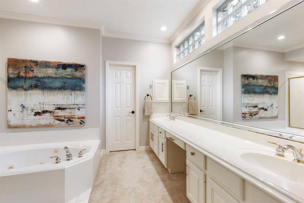 The primary bathroom is equipped with double sinks and vanity.