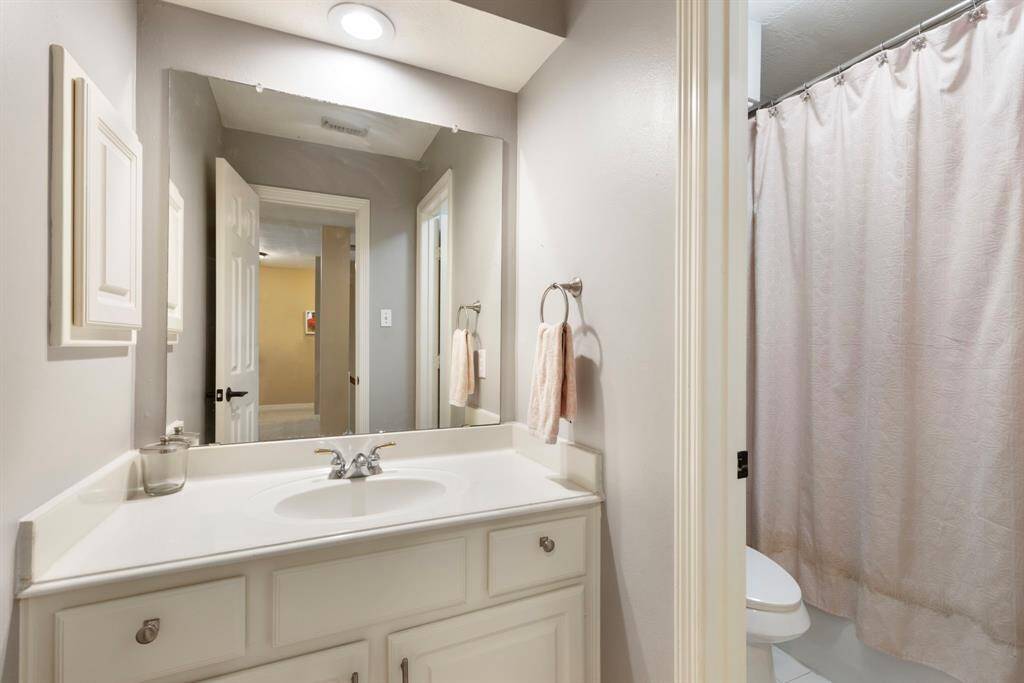 Two secondary bedrooms share this full bathroom.