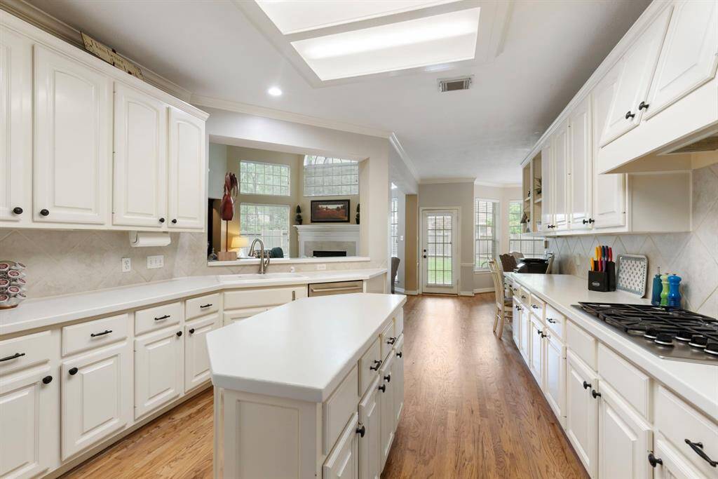 Everything is within reach in the galley-style kitchen. Lots of storage and great counter space for meal prepping!