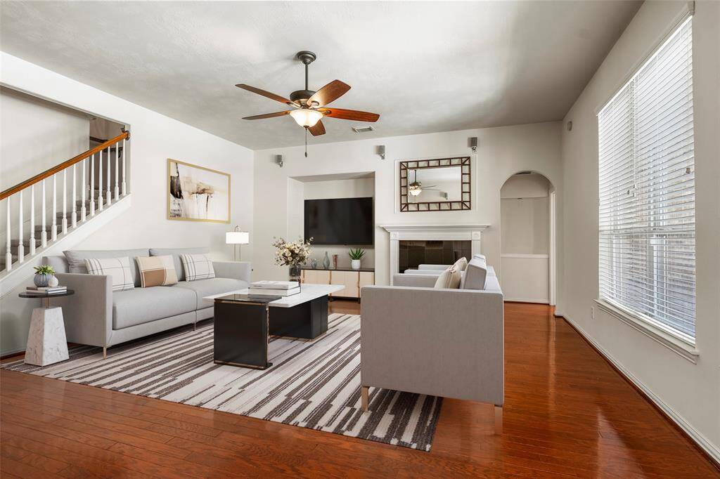 The downstairs living area features an open area with a gas log fireplace and surround  sound speakers for the ultimate movie night