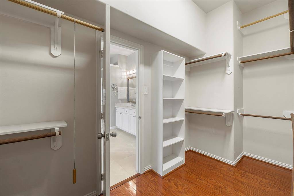 Expansive primary closet with built-in storage solutions.