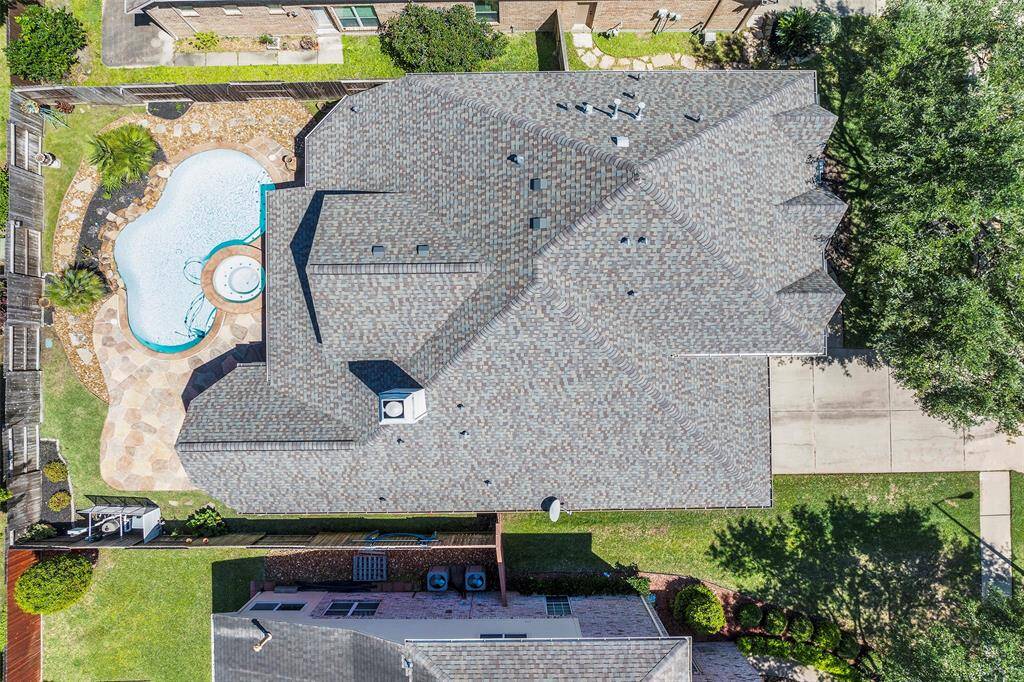 Discover the perfect blend of space and design in this stunning aerial view of the home and lot.