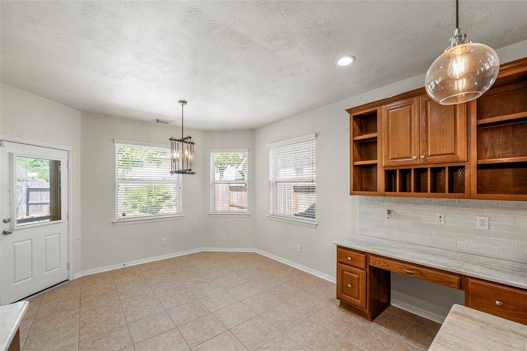 This spacious breakfast area is great for family gatherings and leads to the covered patio and pool/spa.