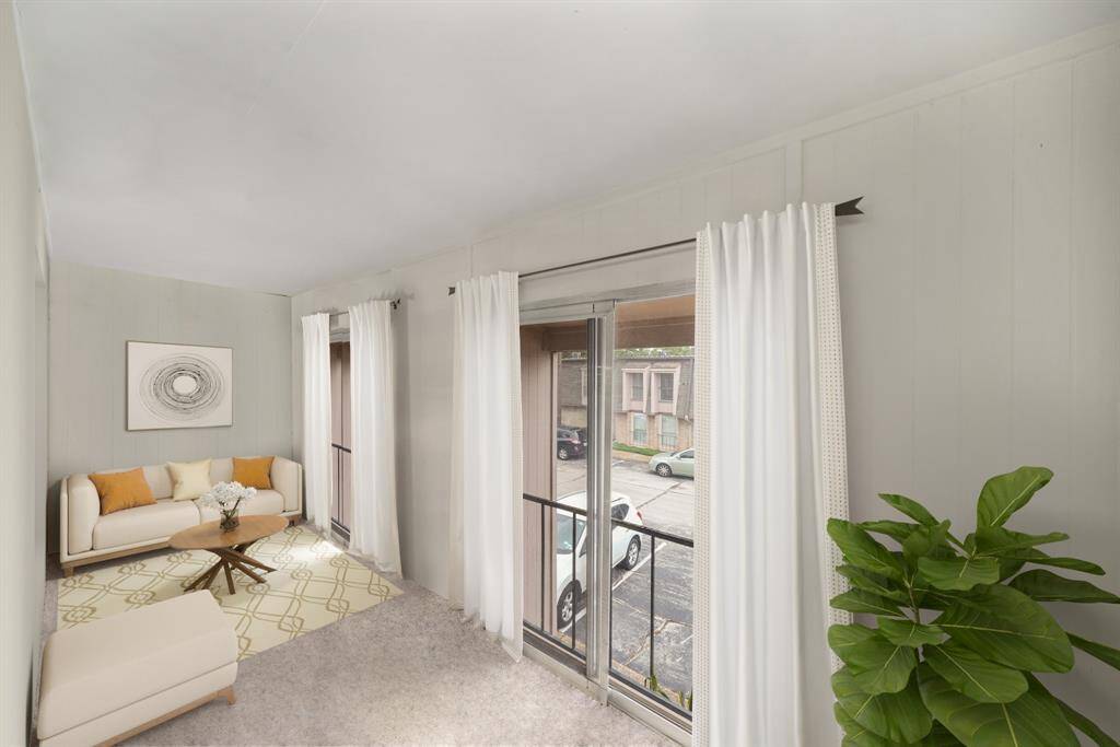 Virtually Staged: Just off of the living room is this bonus sun room featuring large windows and carpet floors.