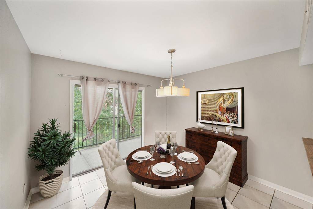 Virtually Staged: Charming dining area with pendant lighting, tile floors, and immediate access to the balcony.