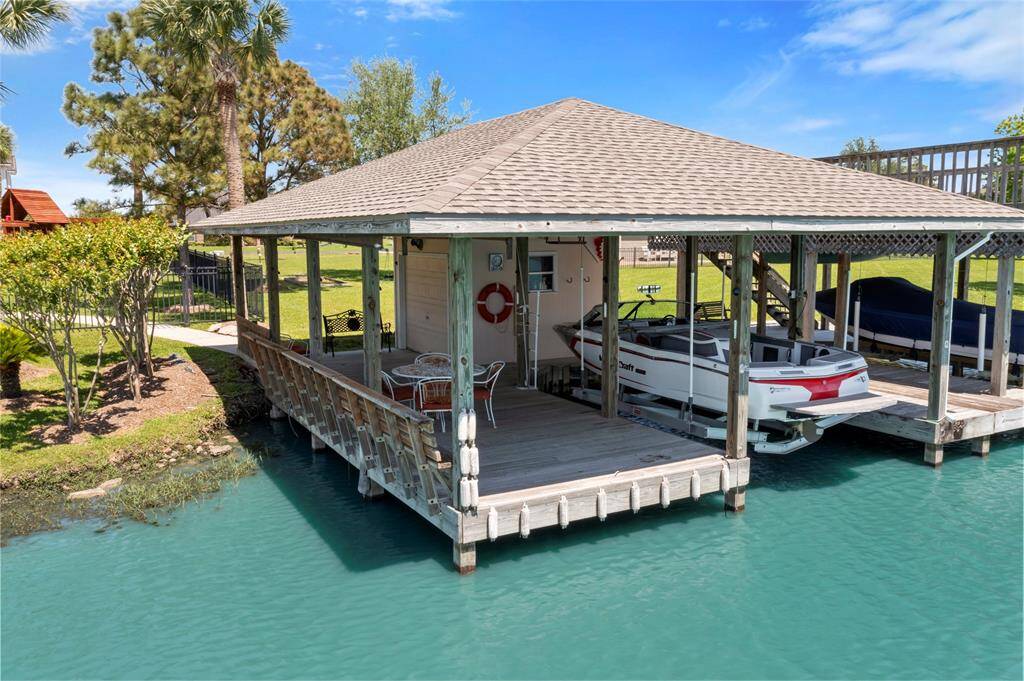 The covered boat dock is equipped with an electronic, aluminum boat lift.