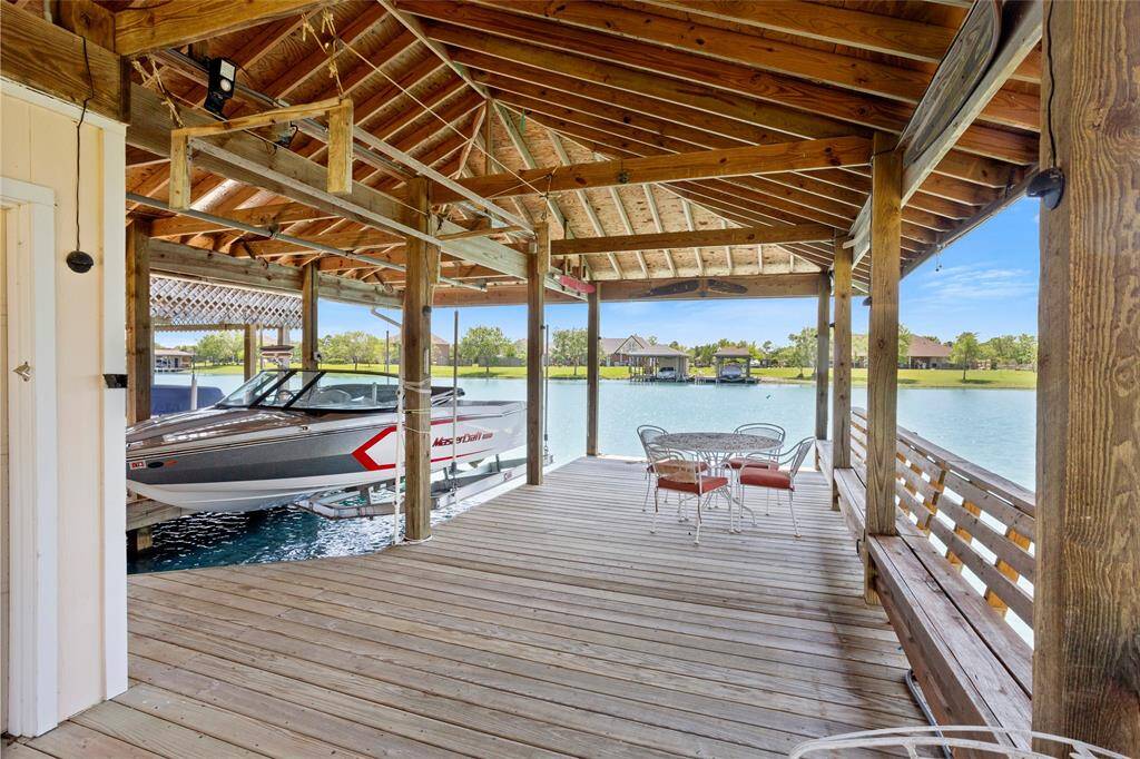 Enjoy tranquil lakeside living with this spacious dock, featuring a covered seating area, direct water access, and stunning views.