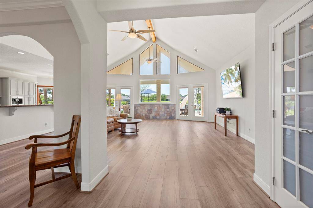 As you walk into this home you are greeted with stunning lake and backyard views through this spacious living area.