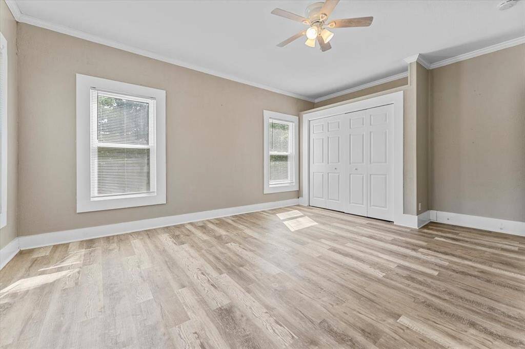 Unit A (triplex). One of two bedrooms, with lots of light and a large closet.