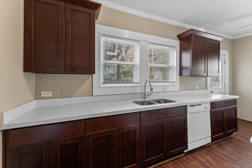 Unit A (triplex). The kitchen features quarts countertops and an updated sink fixture. Lots of natural light.