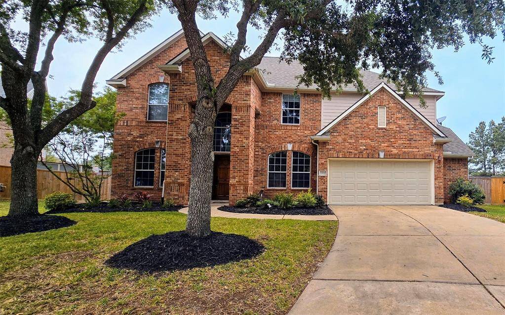 "Freshly landscaped front yard with new mulch and a vibrant selection of perennial plants added for year-round curb appeal."