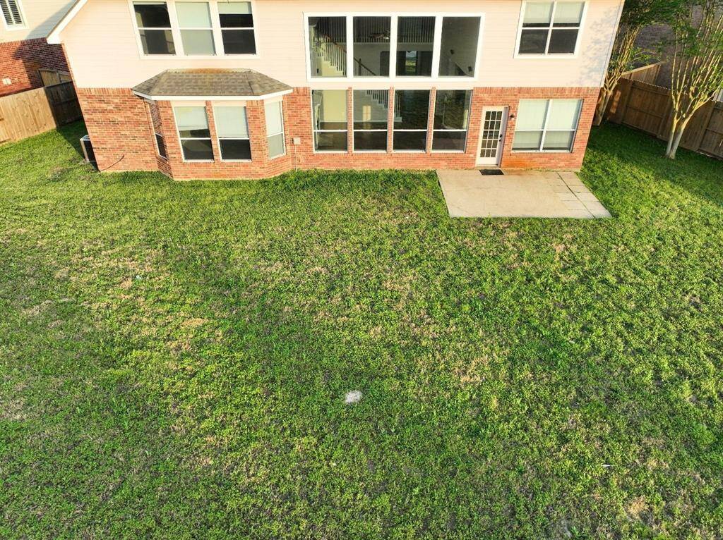 Spacious backyard with endless possibilities for landscaping, recreation, and relaxation. Perfect for hosting big gatherings.