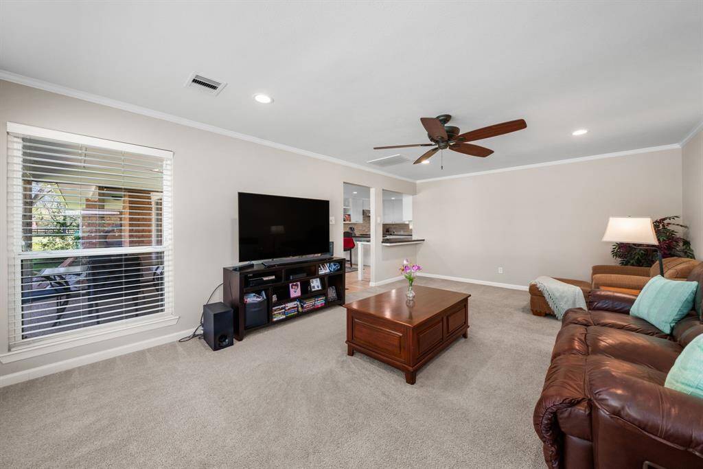 Another view of the den, note the serving bar area off the kitchen in the backgorund.