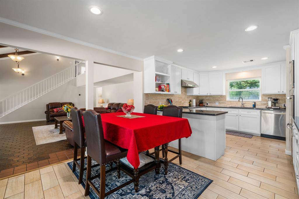 Breakfast room and kitchen have updated tile flooring, abundant lighting and storage galore.