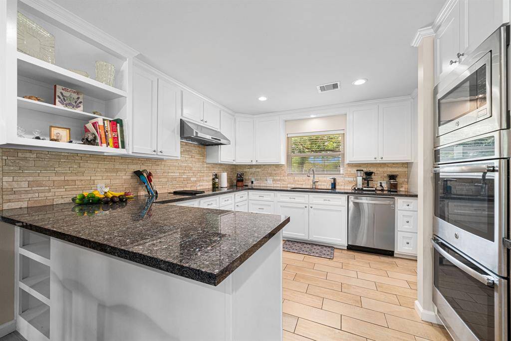 Granite counter tops, new cabinetry and doors, stone backsplash and stainless steel appliances.