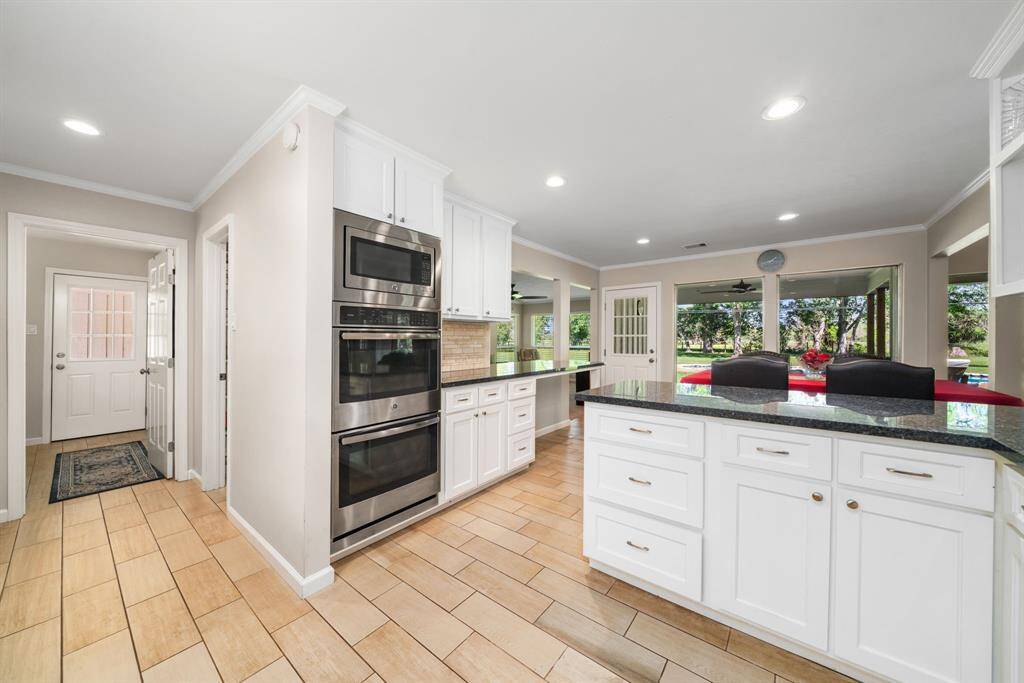 Up to date beauty. Hallway leads to carport area, utility room is on the left and half bath and walk in pantry to the right.