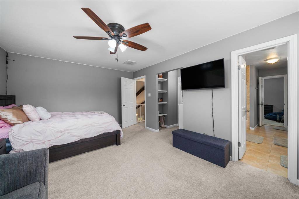 This bedroom feature a cubby for storage, a make up desk area and a good sized closet. The bath connecting this bedroom to the other bedroom services both.
