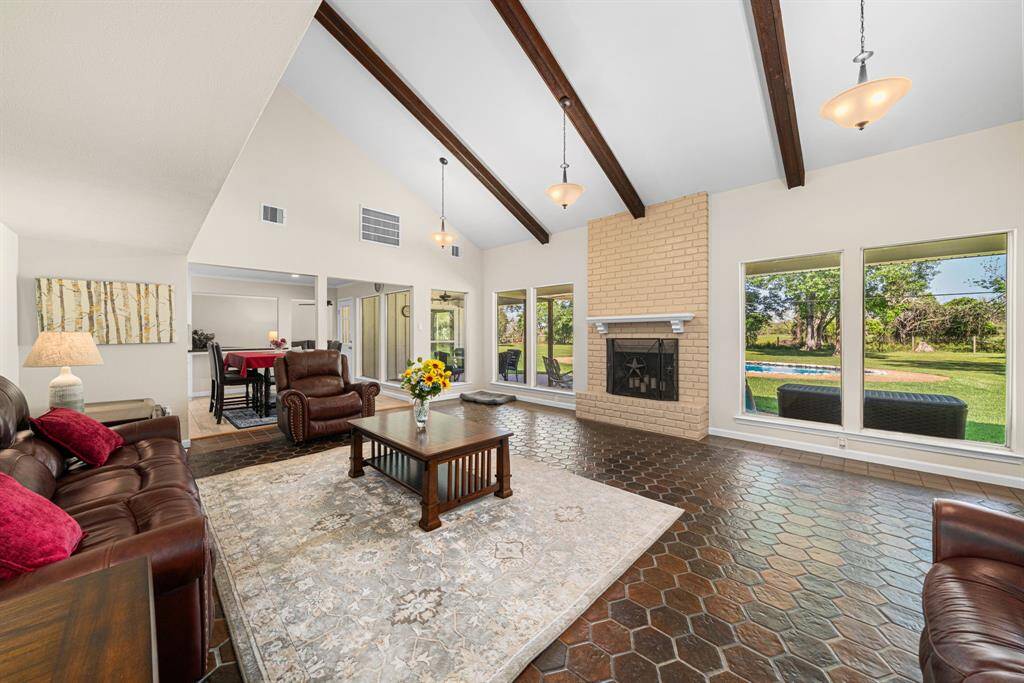 Main living area boasts tile flooring, a gas log fireplace, huge windows, high ceilings and four wood beams. Very spacious and comfortable area. Check out the backyard area views, pool, covered patio and again no rear neighbors. Breakfast room in the background.Please advise and appreciate your time and efforts.BTW way the lease did not call for the 6 month payment upfront. Still willing to do that if needed.