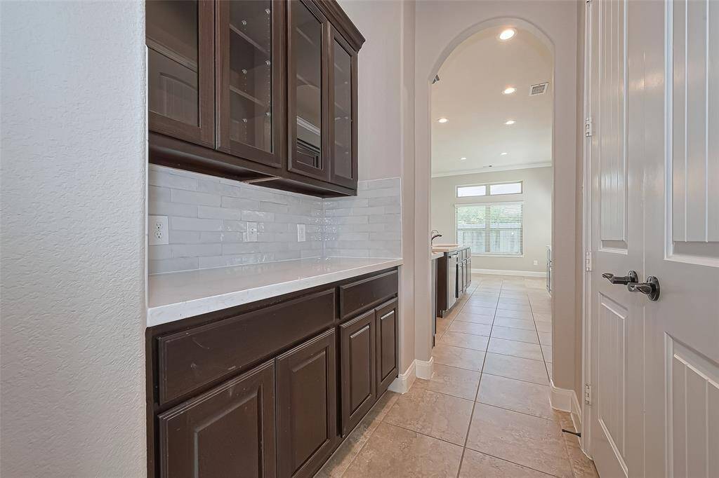 The Butler's Pantry is between the Kitchen and the Dining Room.