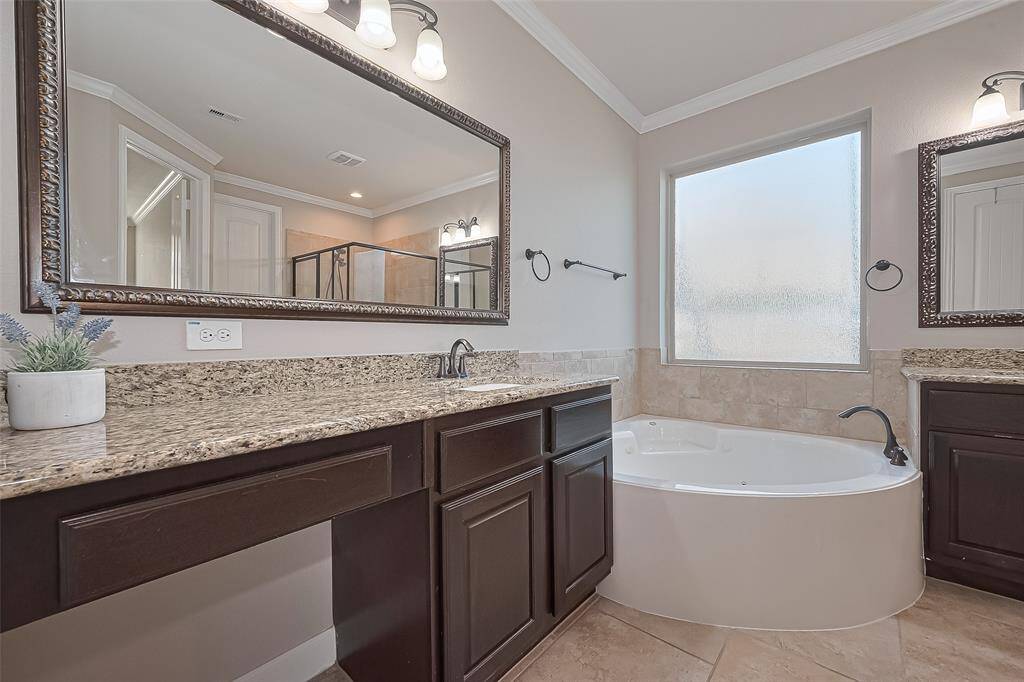 The Primary Bathroom Features Separate Dual Vanities, Oversized Shower with Bench, Soaking Tub, Linen Closet and Large Walk In Closet
