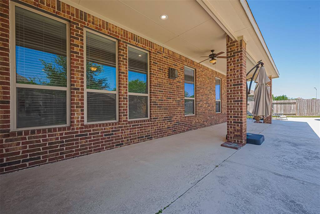 The large covered patio starts at the breakfast area and spans from the Family Room to the Primary Bedroom.