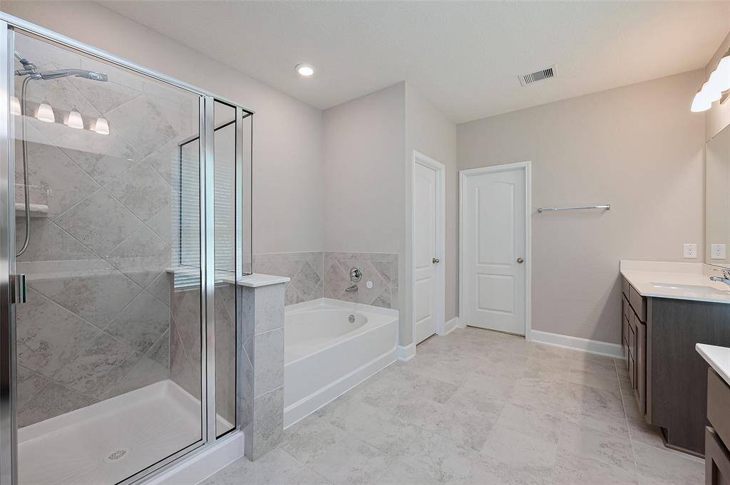 Main bathroom with separate shower and soaking tub.