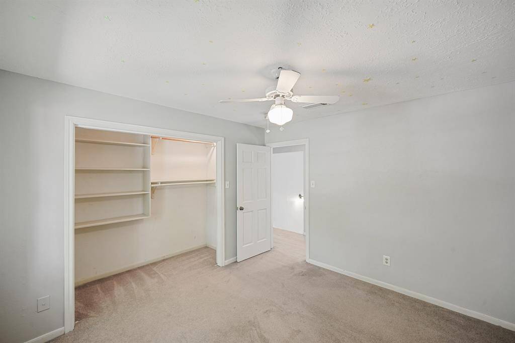 This secondary bedroom has a unique walk-in closet.