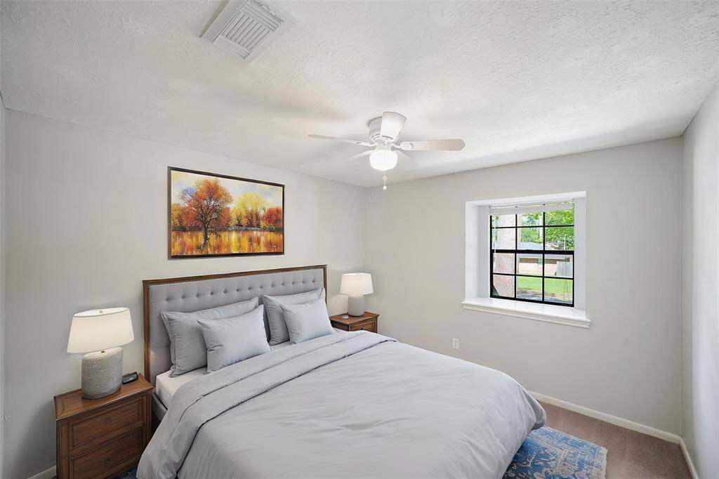 Virtually Staged: Secondary bedroom with carpet floors, and a ceiling fan.