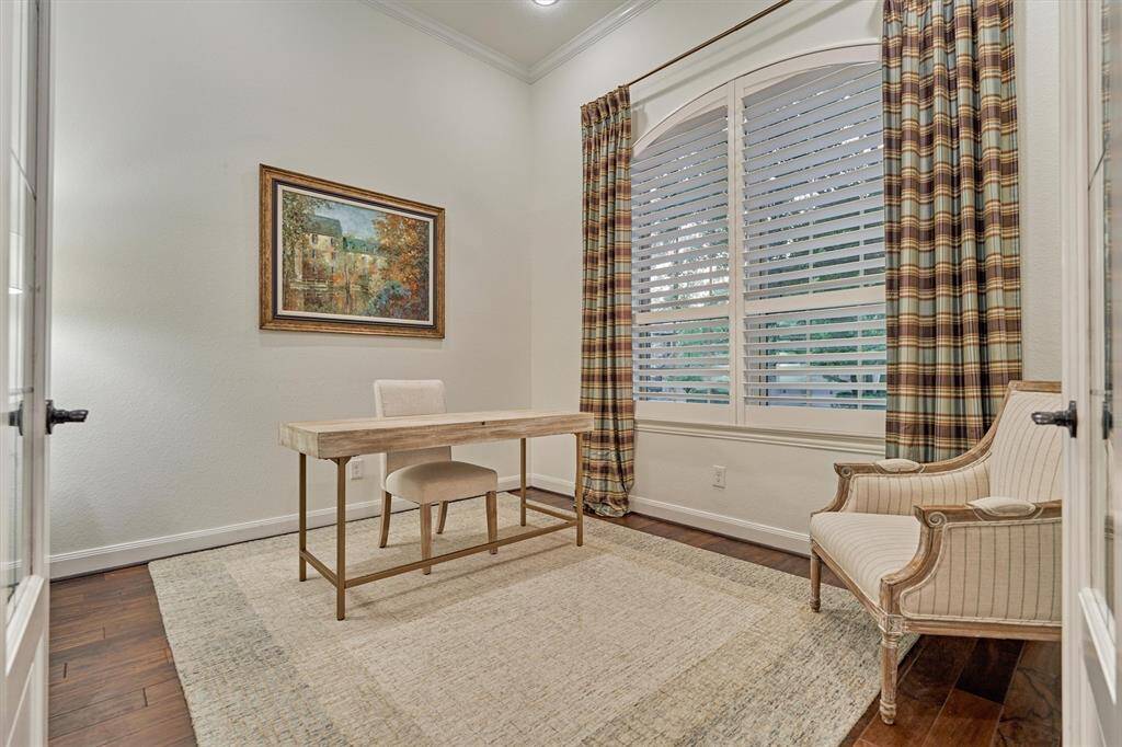 Study showcasing plantation shutters and wood floors