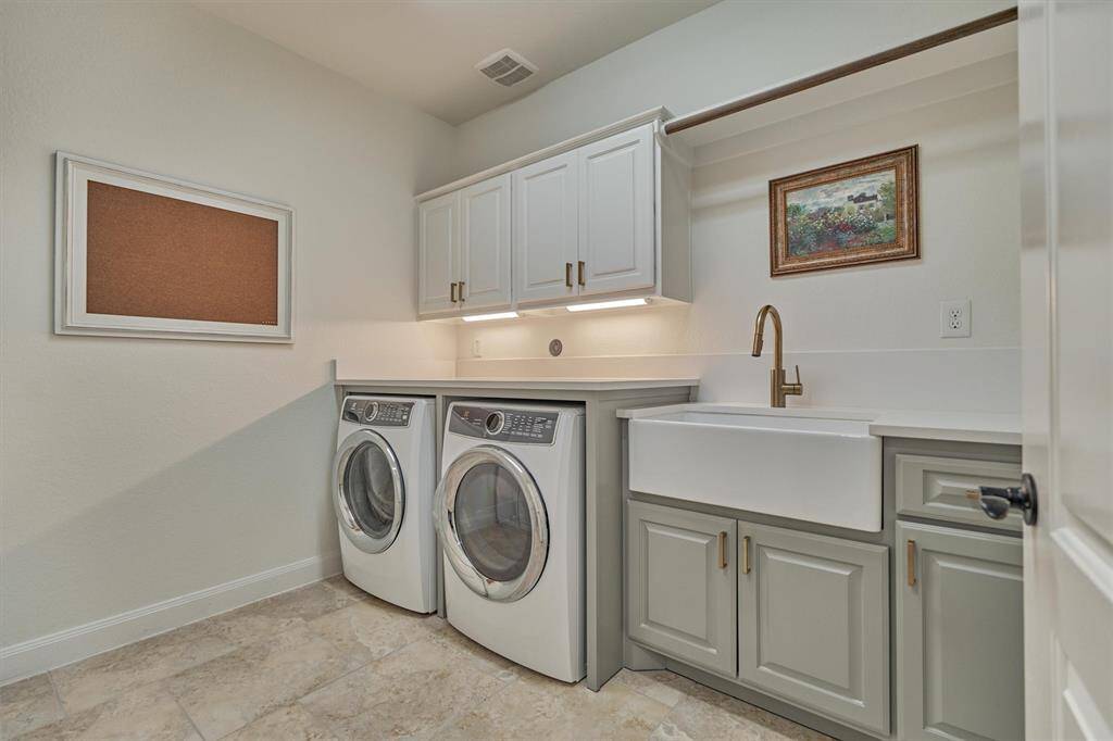 Newly remodeled Spacious Utility with updated cabinets, farm sink, & new quartz countertops