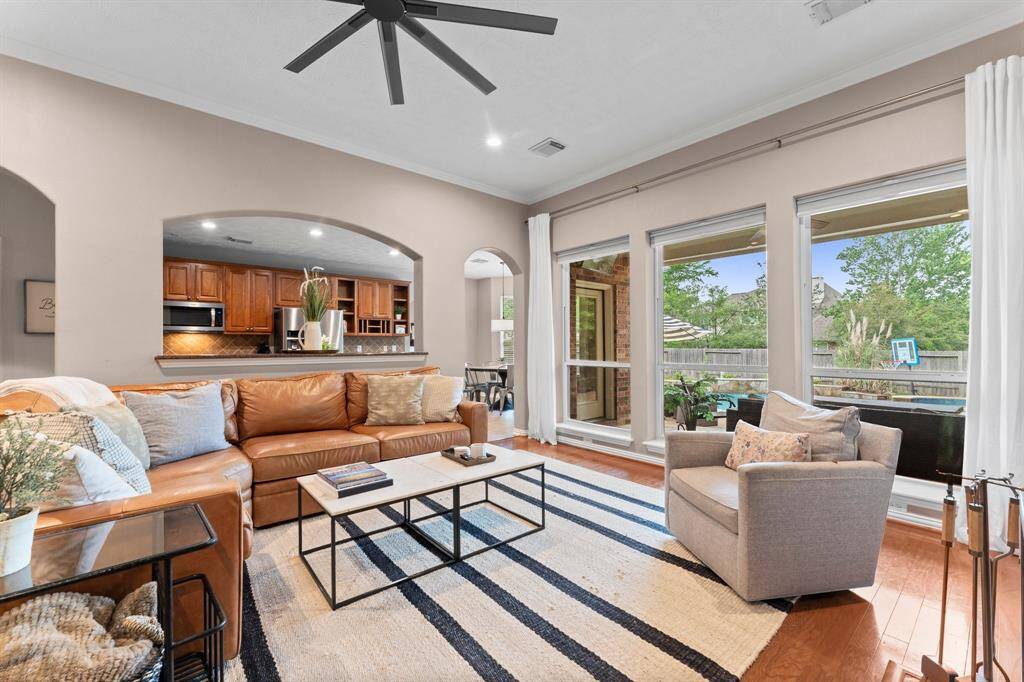 A great view of this home looking toward the kitchen. The arched cutout window adds elegance and function to the open floor plan.
